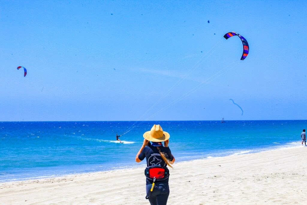 Women taking picture of a kitesurfer in peru north shore