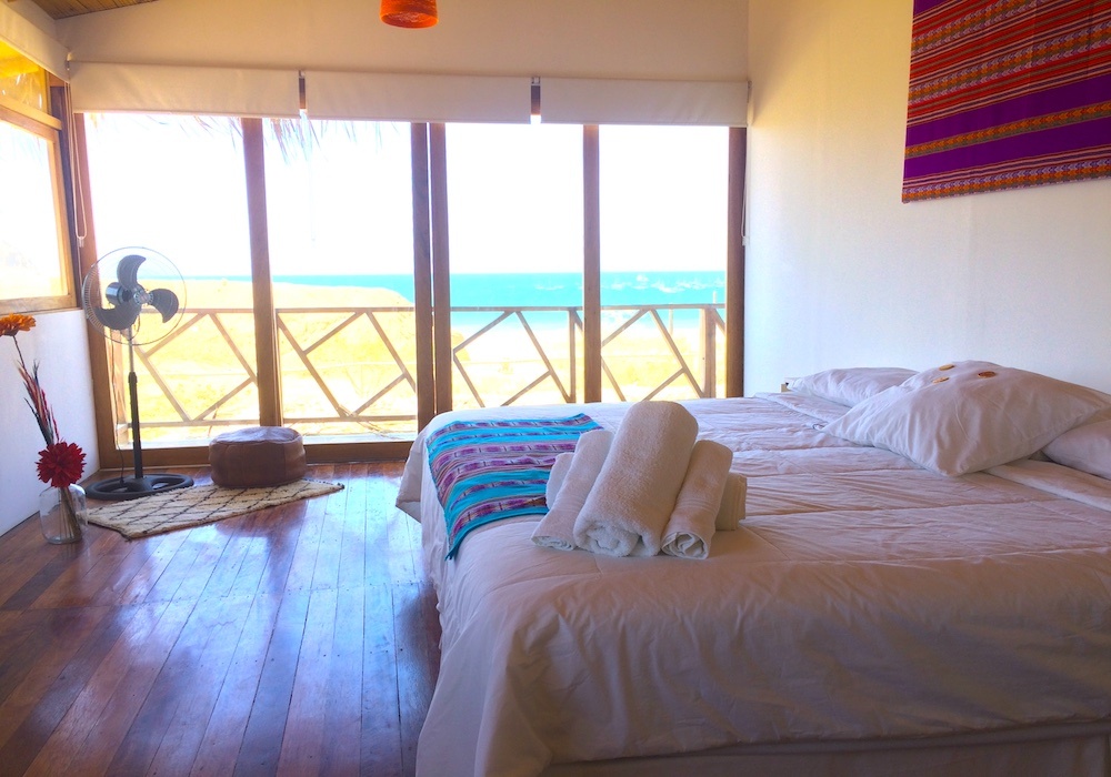 King size bed with ocean view at Surf Racer House Peru