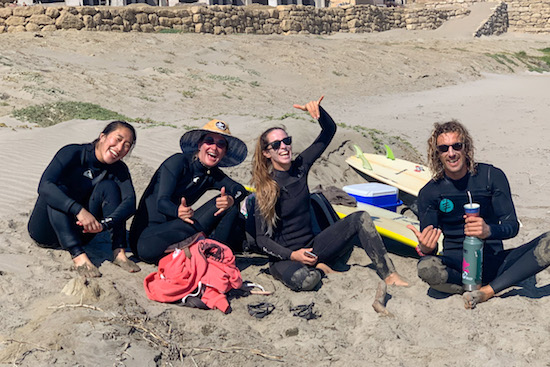 A group of likeminded surfers resting at the beach after a morning Surfing Trip in Peru North break during our Adult´s Surf & Yoga Retreats